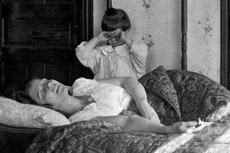 a mother with Spanish Flu symptoms and her young child looking on