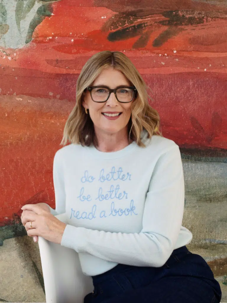 image about Dee Andrews, showing the author in a sweater that says, "Do Better Be Better Read a Book"